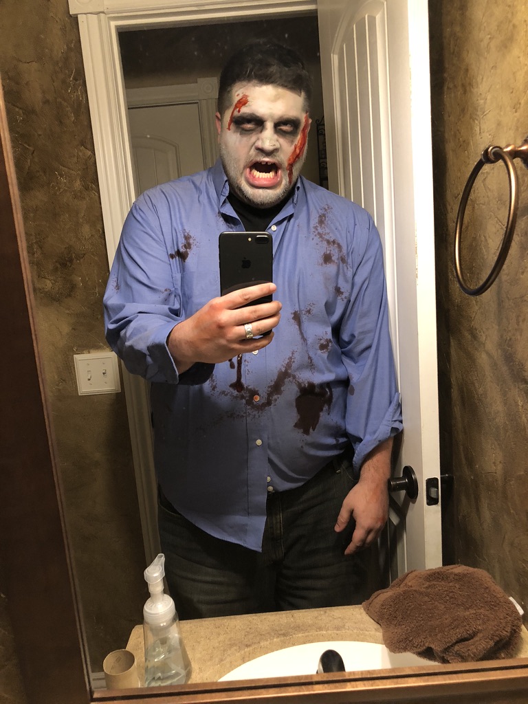 Shawn Lopp in costume taking an iPhone mirror photo
