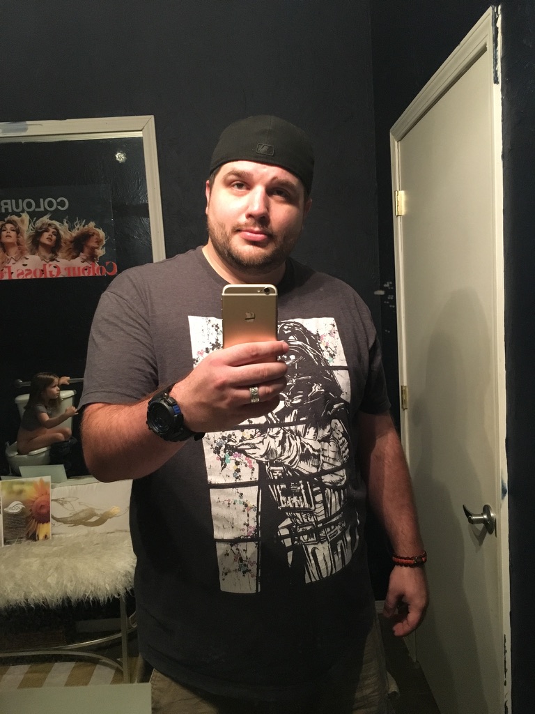 Shawn Lopp taking an iPhone mirror photo in a black room