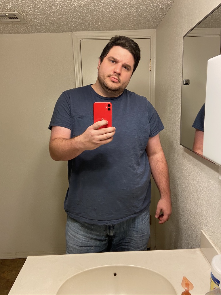 Shawn Lopp holding a red iPhone for a mirror photo