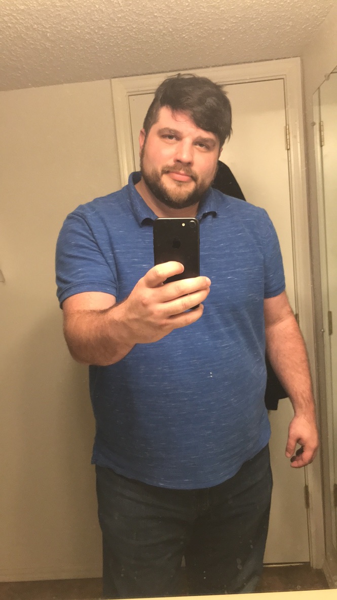 Shawn Lopp taking an iPhone mirror photo in a blue shirt