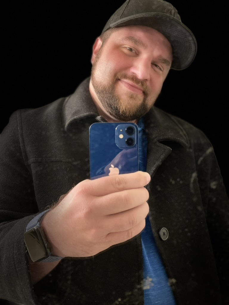 Shawn Lopp taking a close iPhone mirror selfie with a blue phone
