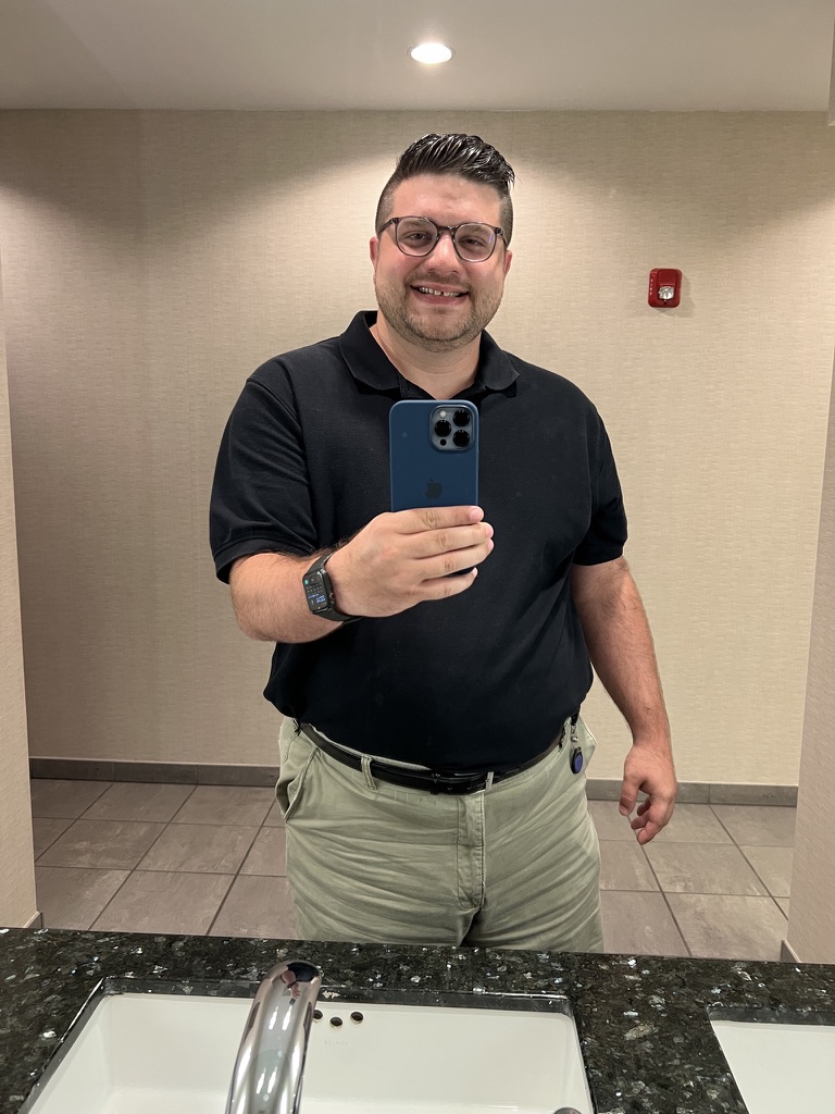 Shawn Lopp holding a blue iPhone for a mirror photo