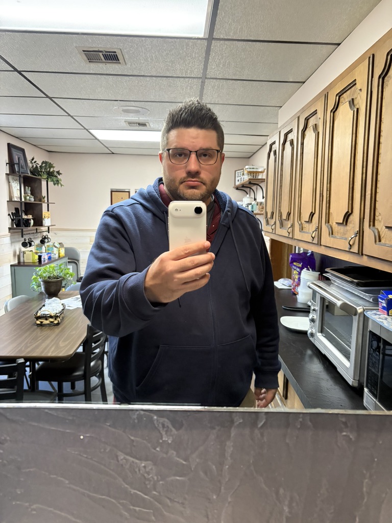 Shawn Lopp taking an iPhone mirror photo in a kitchen