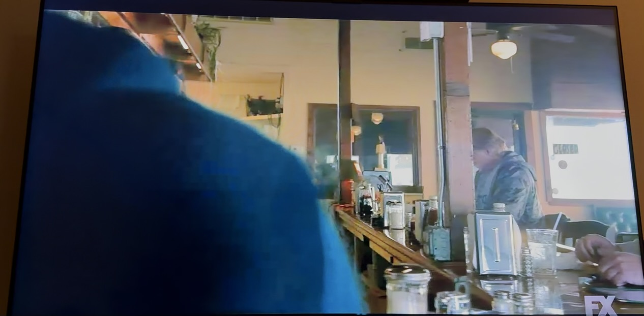 Broadcast frame from The Lowdown with Shawn Lopp in the background at the bar
