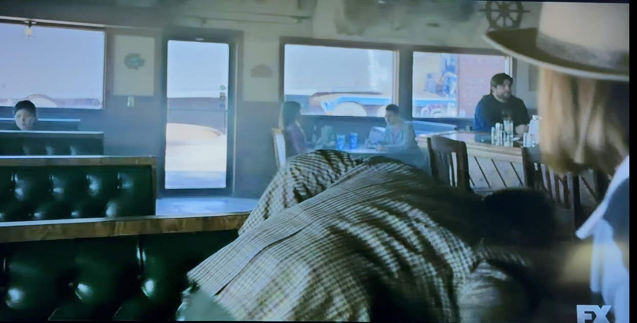 Broadcast frame from The Lowdown with Shawn Lopp visible near the diner counter