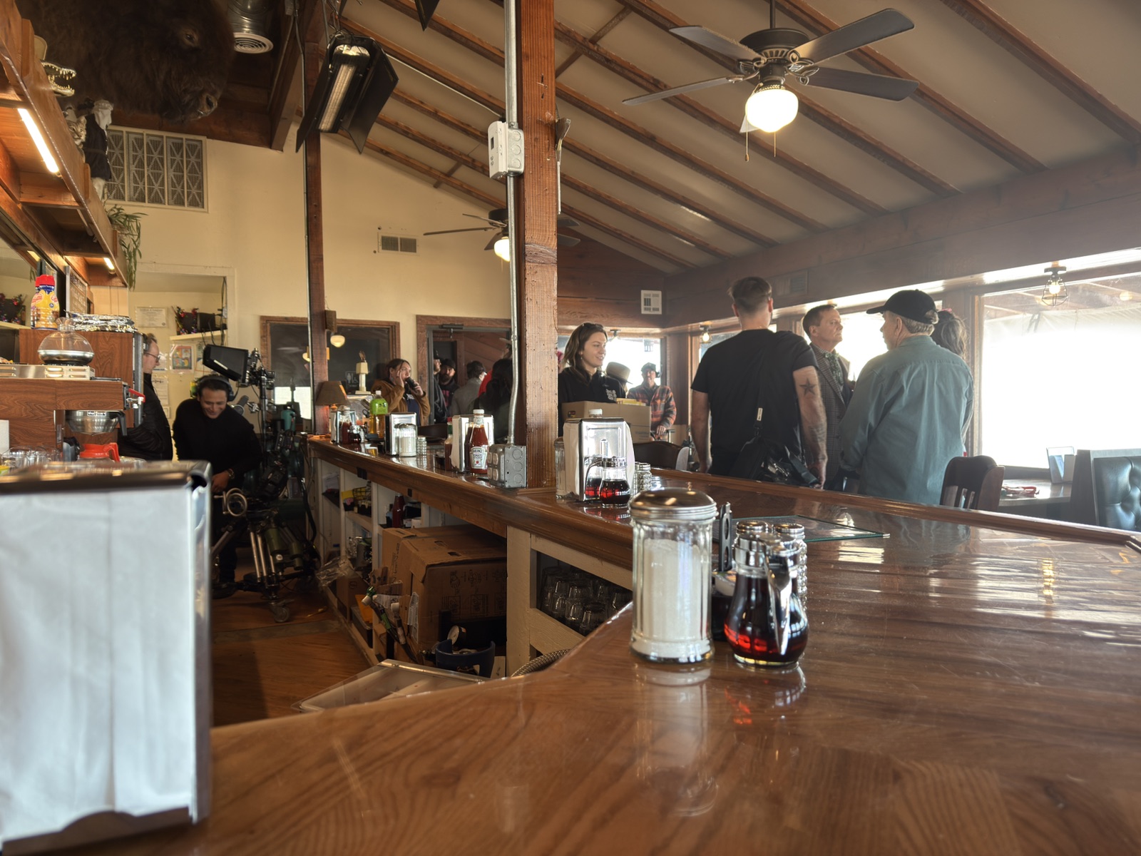 Production crew and equipment filling the restaurant set