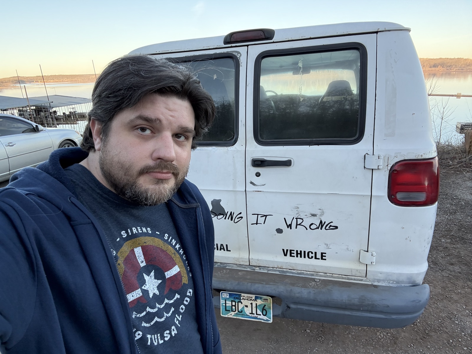 Shawn Lopp taking a selfie with the white prop van